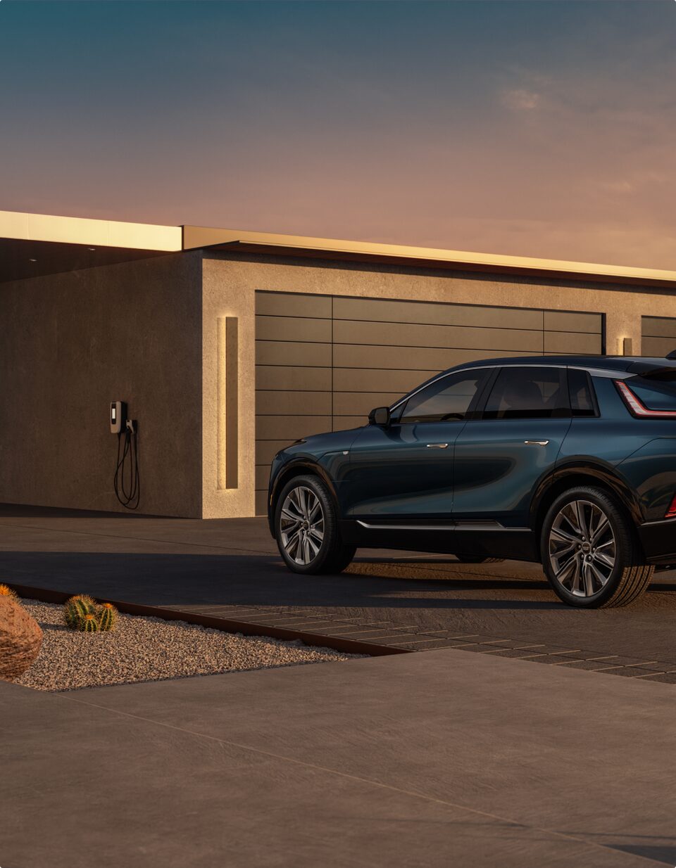 The LYRIQ on the driveway of a home with a Cadillac Wall Box
