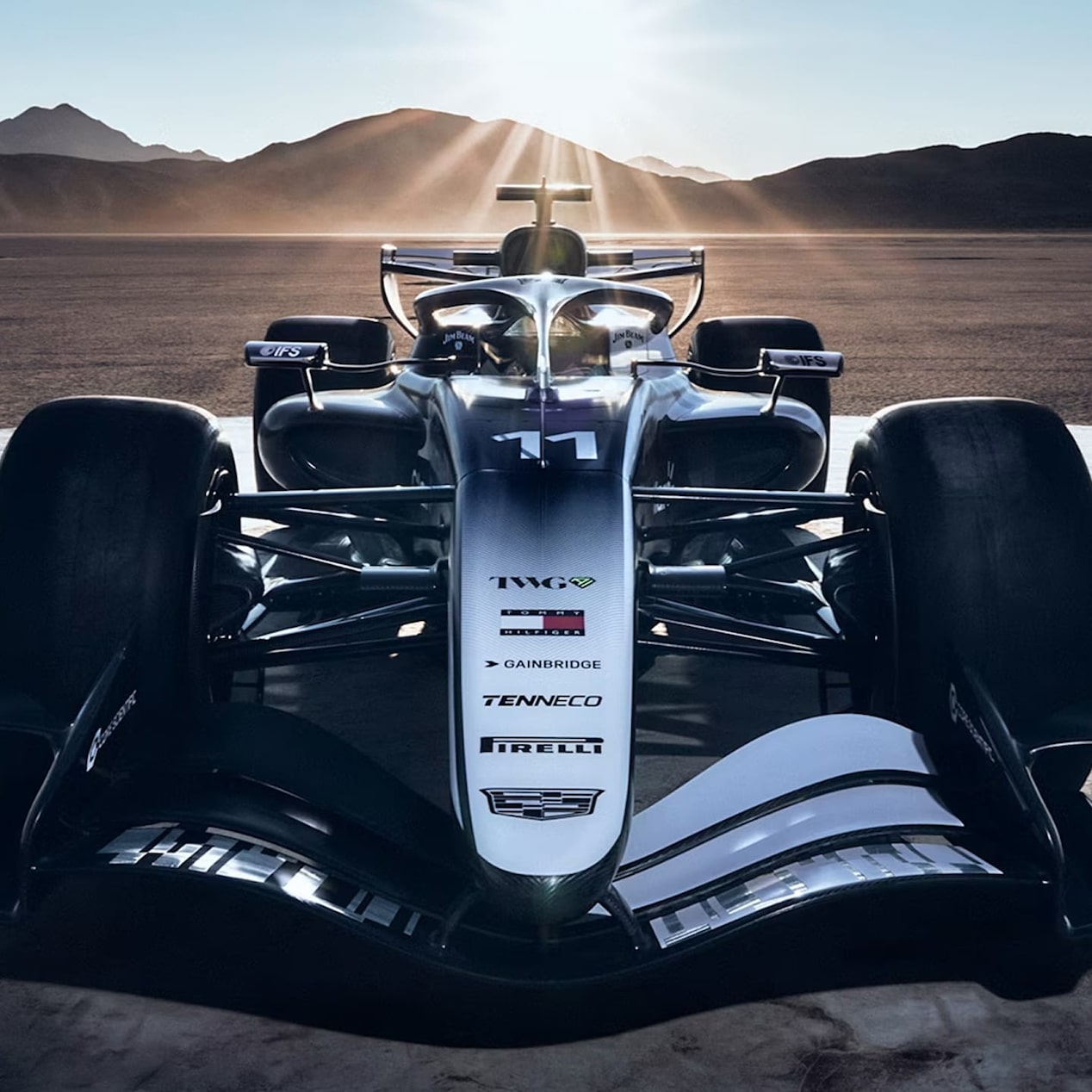 Front on and close up, Cadillac’s F1 car radiates potency, with beaming sun and dramatic desert terrain behind.