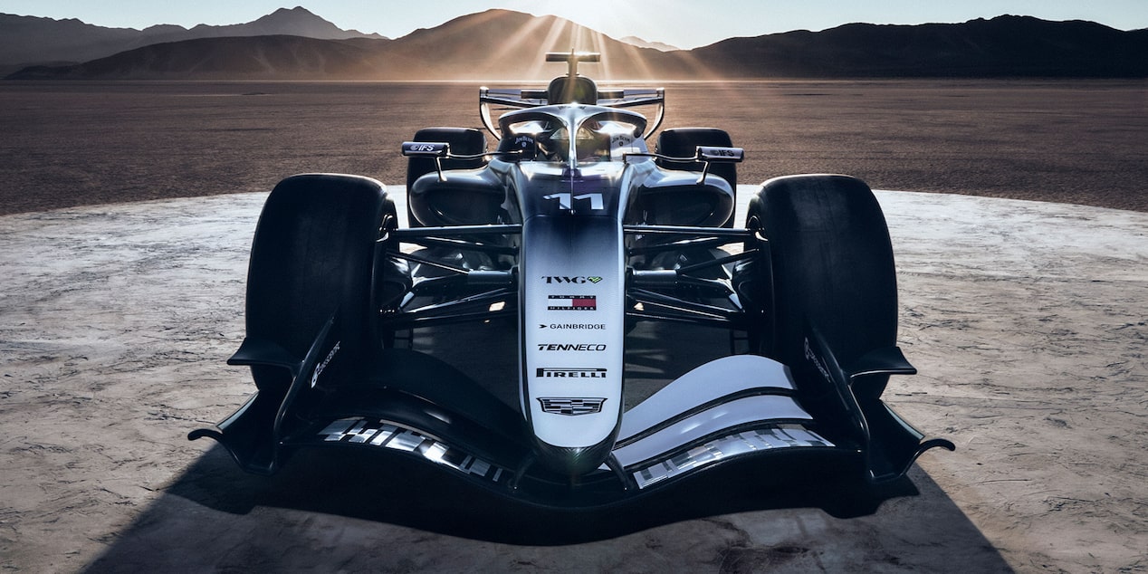 Front on, Cadillac’s F1 car radiates potency, with beaming sun and dramatic desert terrain behind.