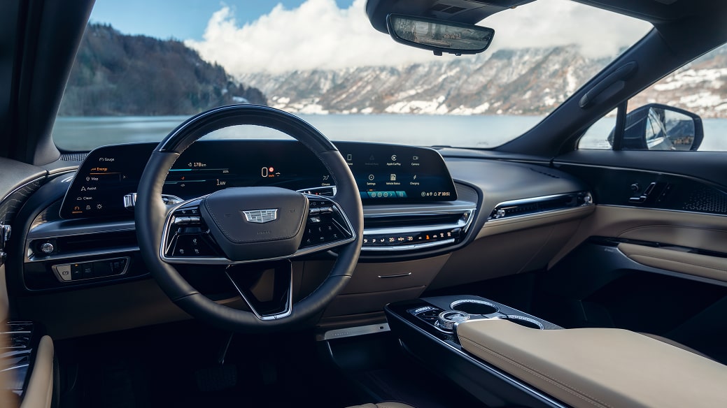 Wide interior view of the Cadillac LYRIQ showing the steering wheel, dashboard, and panoramic digital display.